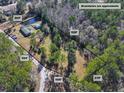 Aerial view of property showing home, detached garage, and pond at 151 Powerhouse Rd, Ridgeville, SC 29472