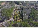 Aerial view of property showing home, detached garage, and pond at 151 Powerhouse Rd, Ridgeville, SC 29472