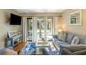 Bright living room with patio access, comfy seating and hardwood floors at 162 High Hammock Villas, Seabrook Island, SC 29455