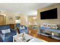 Living room with hardwood floors, comfortable seating, and dining area at 162 High Hammock Villas, Seabrook Island, SC 29455