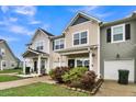 Attractive tan townhome with a front porch and well-manicured landscaping at 162 Kirkland St, Goose Creek, SC 29445