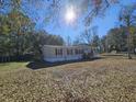 Mobile home exterior with a large yard and trees at 2002 Valnore Rd, Johns Island, SC 29455