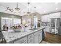 Spacious kitchen with white cabinets, granite island, and stainless steel appliances at 218 River Martin Ct, Summerville, SC 29483