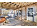 Covered porch with wooden ceiling, seating area, and grill at 250 W Medina St, Summerville, SC 29483