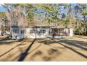 Tan mobile home with covered porch and large grassy yard at 250 W Medina St, Summerville, SC 29483