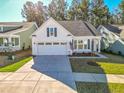 White house with gray roof, American flag, and a 2-car garage at 3204 Cross Vine Ln, Summerville, SC 29483
