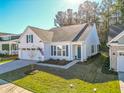 White house with gray roof, American flag, and a 2-car garage at 3204 Cross Vine Ln, Summerville, SC 29483