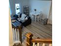 Open living and dining area with L-shaped sectional sofa and hardwood floors at 493 Trotters Ln # 116, Moncks Corner, SC 29461