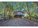 Elevated treehouse home, surrounded by lush trees and offering a unique architectural design at 7 Dunecrest Trace, Seabrook Island, SC 29455