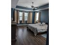Spacious main bedroom with dark wood floors, blue walls, and a king-size bed at 7315 Coopers Hawk Dr, Hanahan, SC 29410