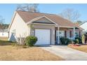 Tan house with brown roof, white garage door, and small front porch at 8419 Creekstone Ct, North Charleston, SC 29406