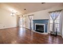 Living room with fireplace, hardwood floors, and sliding glass doors at 8419 Creekstone Ct, North Charleston, SC 29406