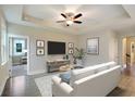 Bright living room with hardwood floors, comfy couch, and a TV at 8625 Connor Ct, North Charleston, SC 29406