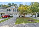 Townhome exterior with driveway, landscaping, and two-car garage at 9632 Scarborough Ct, Summerville, SC 29485