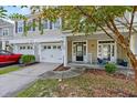 Welcoming front porch with rocking chair and two-car garage at 9632 Scarborough Ct, Summerville, SC 29485