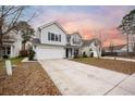 Two-story house with gray siding, a white garage door, and a landscaped yard at 102 Sparkleberry Ln, Ladson, SC 29456