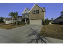Two-story house with a two-car garage and palm trees at 1209 Hammrick Ln, Johns Island, SC 29455