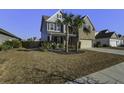 Landscaped lawn and two-story house with a two-car garage at 1209 Hammrick Ln, Johns Island, SC 29455