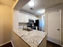 Kitchen features granite countertops and white cabinets at 1530 Fort Johnson Rd # 2 K, Charleston, SC 29412