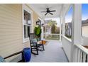 Inviting front porch features rocking chairs and a ceiling fan at 1583 Paradise Lake Dr, Mount Pleasant, SC 29464