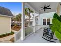 Relaxing front porch with rocking chairs, ceiling fan, and view of neighborhood at 1583 Paradise Lake Dr, Mount Pleasant, SC 29464