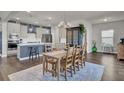 Modern kitchen with stainless steel appliances and an island, adjacent to dining area at 268 Lucca Dr, Summerville, SC 29486