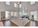 Spacious living room featuring hardwood floors, a beige sofa, and a large TV at 268 Lucca Dr, Summerville, SC 29486