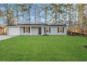 Charming gray house with solar panels and a lush green lawn at 444 Longleaf Dr, Summerville, SC 29483