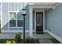 Charming front entrance with a dark brown door and lamp post at 467 Eagleview Drive, Moncks Corner, SC 29461