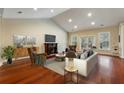 Spacious living room with hardwood floors, fireplace, and access to a balcony at 4712 Westervelt Rd, Meggett, SC 29449