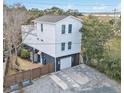 Two-story home with fenced yard and detached garage at 79 Sandbar Ln, Folly Beach, SC 29439