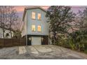 Modern two-story house with gray accents and fenced yard at 79 Sandbar Ln, Folly Beach, SC 29439