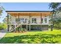 Modern farmhouse with elevated design, large deck, and landscaped yard at 1782 Old Military Rd Rd, Charleston, SC 29412