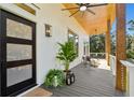 Covered porch features wood ceiling, modern railing, and seating area at 1782 Old Military Rd Rd, Charleston, SC 29412