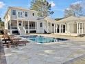 Inviting backyard oasis with a large pool, spacious patio, and covered pavilion at 204 King George St, Charleston, SC 29492
