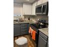 Modern kitchen with granite counters, stainless steel appliances, and dark cabinets at 208 Horseshoe Dr, Goose Creek, SC 29445