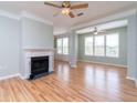 Spacious living room with hardwood floors, fireplace, and large windows at 2333 Chatelain Way, Mount Pleasant, SC 29464