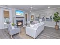 Spacious living room with fireplace, large TV, and comfortable seating at 270 Darby Meadow Ln, Ridgeville, SC 29472