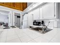Clean and bright kitchen with white cabinets and tile countertops at 279 Driftwood Ln, Edisto Beach, SC 29438