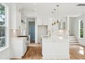 Spacious white kitchen with stainless steel appliances and hardwood floors at 4430 Beaver St, North Charleston, SC 29405
