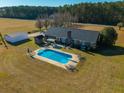 Inviting in-ground pool with ample deck space and surrounding yard at 534 Farmers Market Rd, Saint George, SC 29477