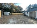 Spacious backyard with a wooden fence and shed at 5614 Read St, North Charleston, SC 29406