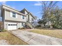 Two-story house with a driveway, gray siding, and a spacious yard at 8048 New England Dr, North Charleston, SC 29420