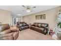 Living room with brown leather couches, a large TV, and a Christmas tree at 8048 New England Dr, North Charleston, SC 29420