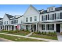 Row of charming two-story homes with white siding and black shutters at 1011 Swamp Harrier Ave, Ravenel, SC 29470