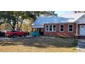 Red truck parked in front of a brick home with a metal roof at 12240 Green Pond Hwy, Green Pond, SC 29446