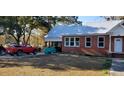 Red truck parked near brick home with metal roof and carport at 12240 Green Pond Hwy, Green Pond, SC 29446