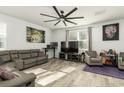 Spacious living room with gray sectional sofa, large TV, and hardwood floors at 135 Sunray Ln, Summerville, SC 29486