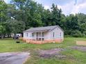 White house with a porch and a fenced backyard at 159 Hayes Ln, Williams, SC 29493