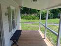 Relaxing front porch with wooden flooring and bench at 159 Hayes Ln, Williams, SC 29493